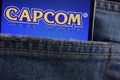 Capcom logo displayed on smartphone hidden in jeans pocket Royalty Free Stock Photo