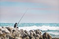 CAPE AGULHAS, SOUTH AFRICA, 11 AUGUST 2018 - Young boy fishing in Cape Agulhas, the southern most point in Africa.