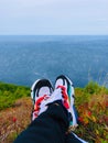 Beautiful view of sea from hills with pair of colorful shoes.