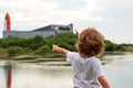 Cape Canaveral, FL, USA - MAY 27, 2020: The big dream of space. The child points a finger at the space center. NASA