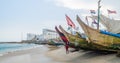 Cape Coast, Ghana - February 15, 2014: Colorful moored wooden fishing boats in African harbor town Cape Coast Royalty Free Stock Photo