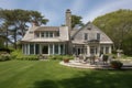 cape cod house exterior, with view of expansive lawn and gardens