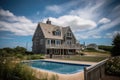 cape cod house with private beach access, view of the ocean, and swimming pool