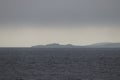 Cape Crillon of Sakhalin Island in fog. Lighthouse Crillon. Sakhalin Island, La Perouse Strait, The Sea of Okhotsk, Russia.