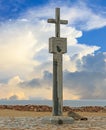 Cape Cross Monument with a seal lying at the base, with a nice cloudy sky