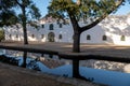 Cape Dutch style farm building at Groot Constantia, Cape Town, South Africa, reflected in a pond in the early morning. Royalty Free Stock Photo