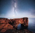 Cape Dyrholaey at southern Iceland. Altitude 120 m, and mean hill island with a door opening. Vibrant night sky with Royalty Free Stock Photo