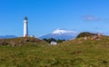 Cape Egmont lighthouse and Mount Taranaki view, New Zealand Royalty Free Stock Photo