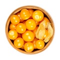 Cape gooseberries, fruits of Physalis peruviana, in a wooden bowl Royalty Free Stock Photo