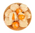 Cape gooseberry or physalis in wooden bowl isolated on white background wit full depth of field. Top view. Flat lay Royalty Free Stock Photo
