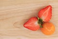 Cape gooseberry and strawberry on wooden background with space for text Royalty Free Stock Photo