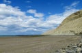 Cape with gray cliffs in the ocean