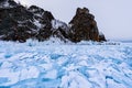 Cape Hoboy in Olkhon island covered with icicles in sunny march day. Lake Baikal with cloudy sky and big blocks of blue Royalty Free Stock Photo