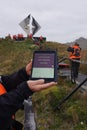 Tourist holds I pad with Cape Horn coordinates