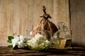 Cape jasmine or Gardenia jasminoides flowers and oil on an old wood background Royalty Free Stock Photo