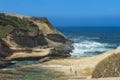 Cape Kiwanda`s cliffs drawf those below exploring it`s shores