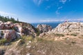 Cape Sagan-Khushun against the background of the blue sky and blue water of the Maloye More Strait. Olkhon Island, Lake Baikal