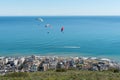 Three tandem paragliders above Sea Point