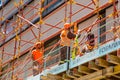 Construction workers on scaffolding on building site