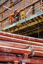 Construction workers on scaffolding on building site Royalty Free Stock Photo