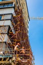 Construction workers on scaffolding on building site Royalty Free Stock Photo