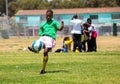 Diverse children playing soccer football at school