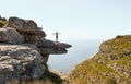 Girl on a rock overlooking the sea.