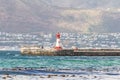 View from St James beach over Kalk Bay recreational harbour and breakwater lighthouse built in 1919 in |False Bay, Cape Town