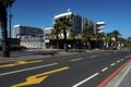 Main road with yellow marking as road sign passing near Waterfront precinct with modern buildings. Royalty Free Stock Photo