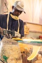 An African Craftsman surfboard Shaper working in a repair workshop
