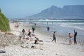 Bathers at Bloubergstrand beach in Cape Town with Table Mountain in the background Royalty Free Stock Photo