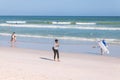 People walking, resting and swimming on Muizenberg beach, South Africa Royalty Free Stock Photo