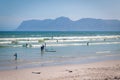 People walking, resting and swimming on Muizenberg beach, South Africa Royalty Free Stock Photo