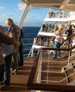 Passengers line the decks of a cruise ship on departure from port Royalty Free Stock Photo