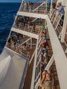 Passengers line the decks of a cruise ship on departure from port Royalty Free Stock Photo