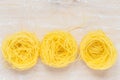Capellini pasta nests on the board Royalty Free Stock Photo