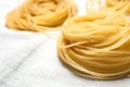 Capellini pasta on white tablecloth, closeup Royalty Free Stock Photo