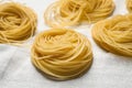 Capellini pasta on white tablecloth, closeup Royalty Free Stock Photo
