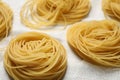 Capellini pasta on white tablecloth, closeup view Royalty Free Stock Photo