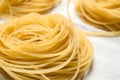 Capellini pasta on white tablecloth, closeup Royalty Free Stock Photo