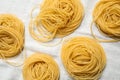 Capellini pasta on white tablecloth, flat lay Royalty Free Stock Photo