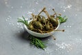 Capers. Marinated or pickled canned capers fruit with fresh rosemary in a small bowl, on gray background. place for text, top view Royalty Free Stock Photo