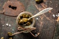 Capers on wooden background. Edible flower buds of Capparis spinosa, caper bush or Flinders rose. close up. top view Royalty Free Stock Photo