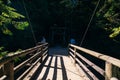 Capilano bridge, Vancouver, Canada, running through a lush, wooded valley, with mountains in the background Royalty Free Stock Photo