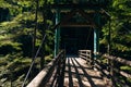 Capilano bridge, Vancouver, Canada, running through a lush, wooded valley, with mountains in the background Royalty Free Stock Photo