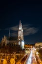 Capital of Austria Vienna at night, view on gothic church and streets of the city Royalty Free Stock Photo