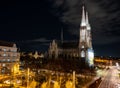 Capital of Austria Vienna at night, view on gothic church and streets of the city Royalty Free Stock Photo