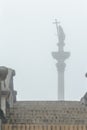 Capital city landmark Sigismund's Column silhouette in fog view from stone stairs in Polish Warsaw