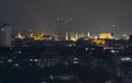 The capital city of Thailand is decorated with bright lights at night. Visible from a distance