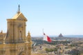 Capital city Victoria top view from Cathedral of the Assumption, Gozo with Maltese flag. Island city architecture panorama Royalty Free Stock Photo
